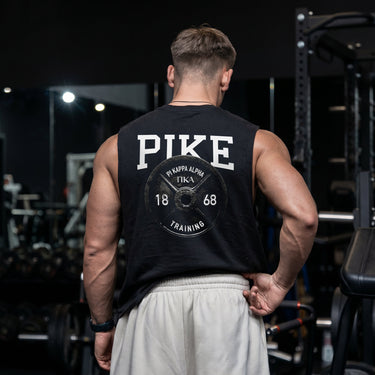 Man wearing a black cut off tank with premium grunge gym design