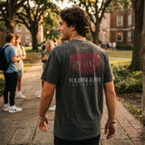 College student wearing fraternity grey t-shirt with colorful flag design on back