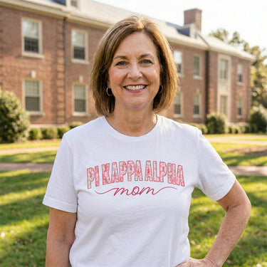 Woman wearing a white t-shirt with large chest logo detail.
