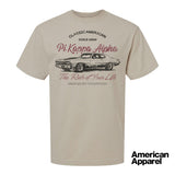 Beige T-shirt displayed on a plain background with a vintage-inspired graphic of a classic muscle car, mixed typography, and a soft red and black print design.