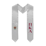 White graduation stole decorated with Greek letters and Coat of Arms