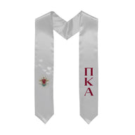White graduation stole decorated with Greek letters and Coat of Arms