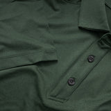Close up image showing the green heathered Cutter & Buck polo